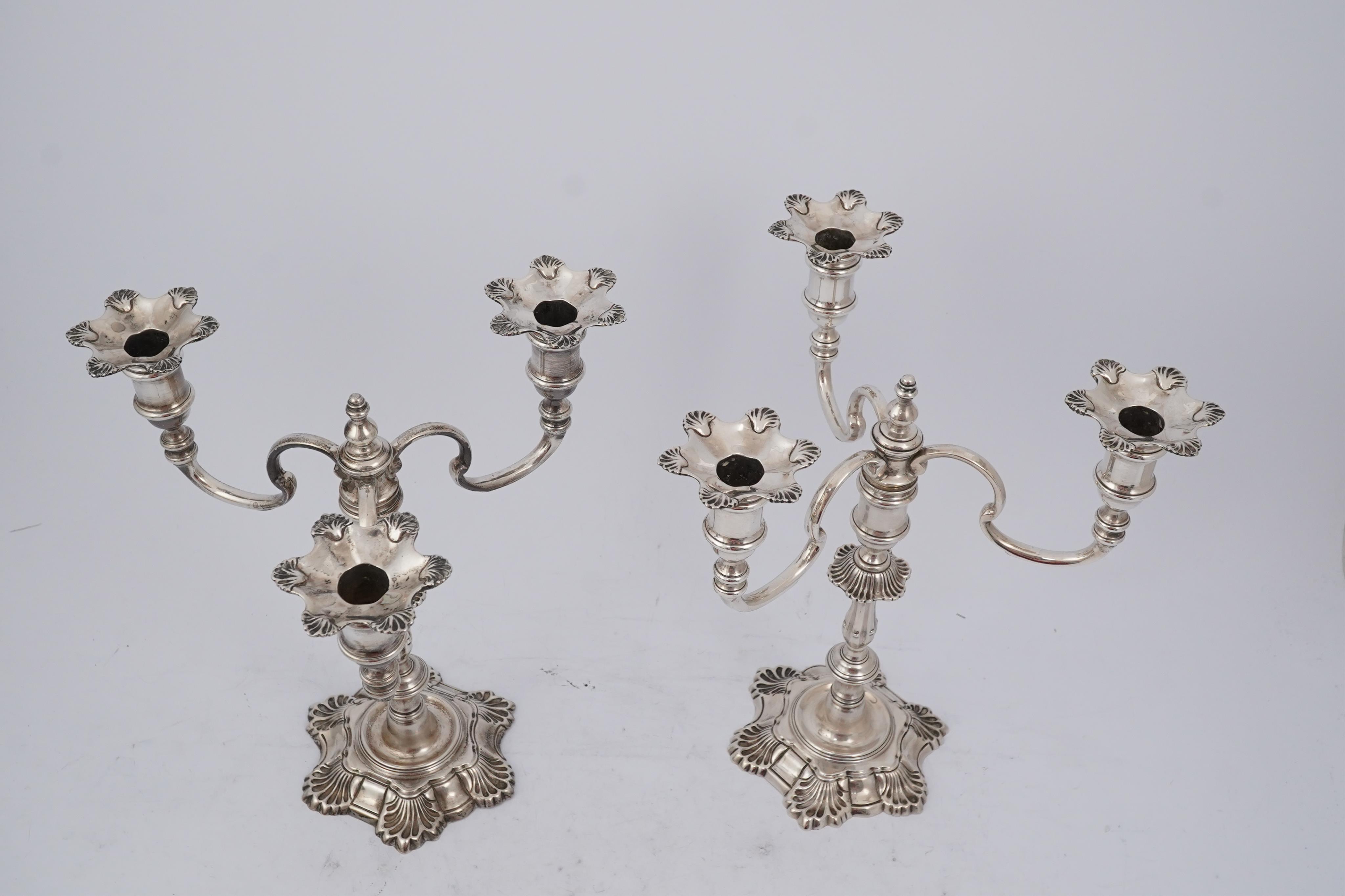 A pair of Elizabeth II cast silver three branch, three light candelabra, by J.B. Chatterley & Sons Ltd